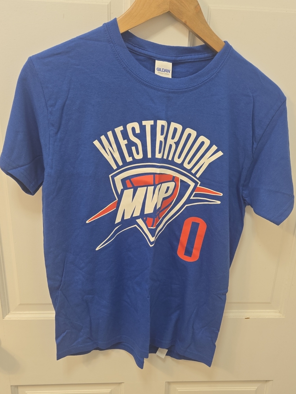 Russell Westbrook Oklahoma City Thunder "MVP 0" graphic t-shirt on a wooden